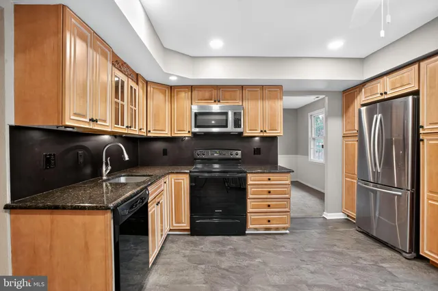 a kitchen with stainless steel appliances granite countertop a stove and a refrigerator