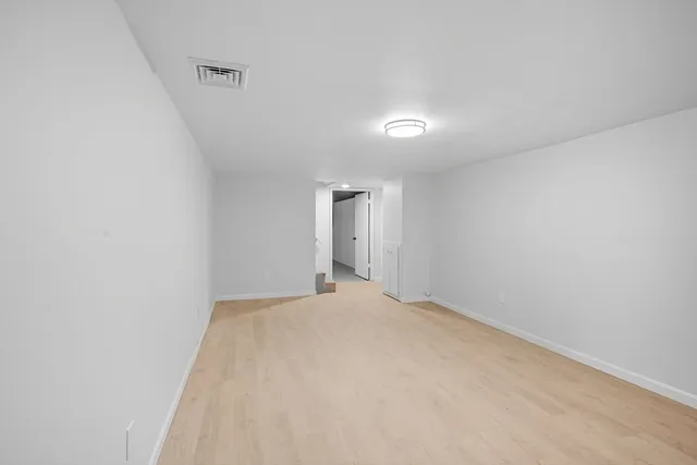 a view of an empty room and a window