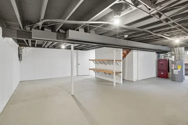a view of water heater room with refrigerator