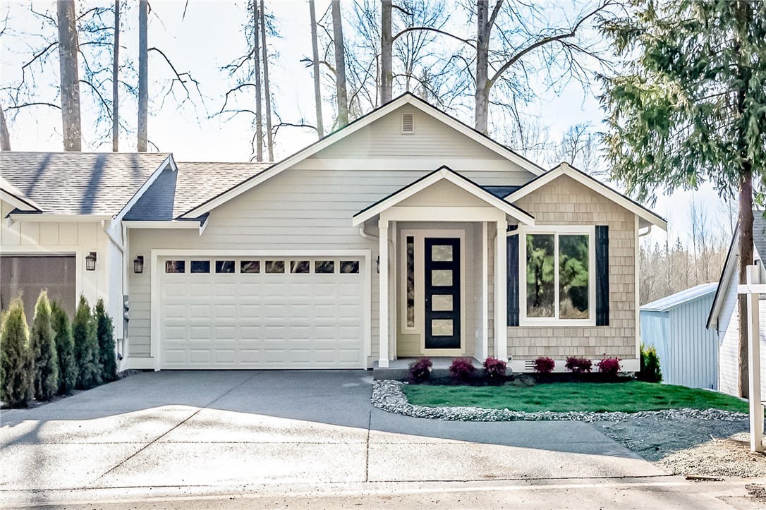 2624 Callow Road, Unit B Lake Stevens, WA 98258 - Photo 1 of 37 a view of a white house with a small yard plants and a large tree