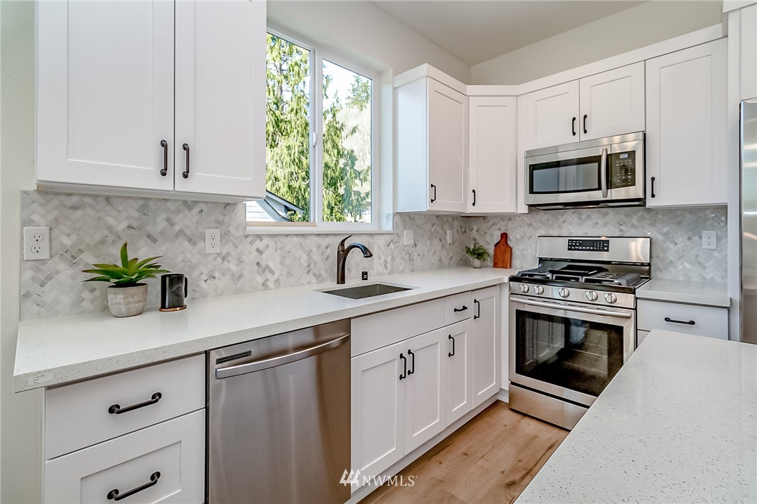 2624 Callow Road, Unit B Lake Stevens, WA 98258 - Photo 12 of 37 a kitchen with stainless steel appliances granite countertop white cabinets a sink and a window