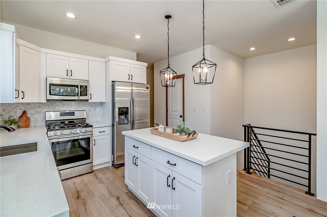 2624 Callow Road, Unit B Lake Stevens, WA 98258 - Photo 14 of 37 a kitchen with kitchen island white cabinets and stainless steel appliances