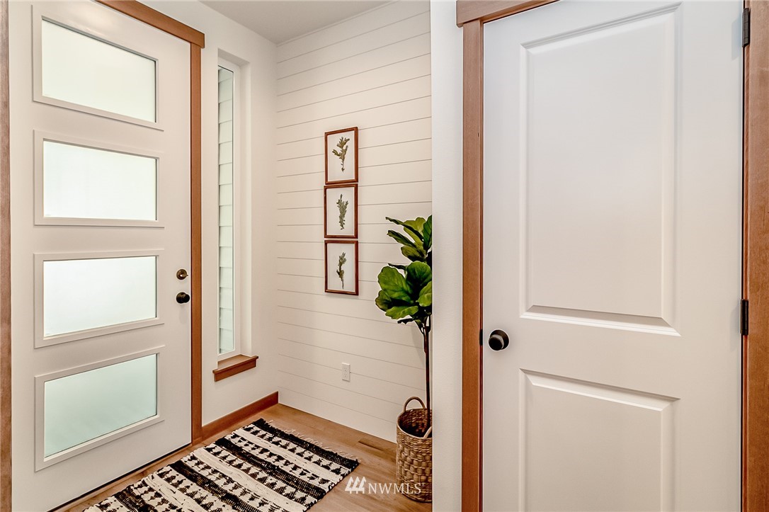 2624 Callow Road, Unit B Lake Stevens, WA 98258 - Photo 3 of 37 a view of a hallway with wooden floor and a bathroom
