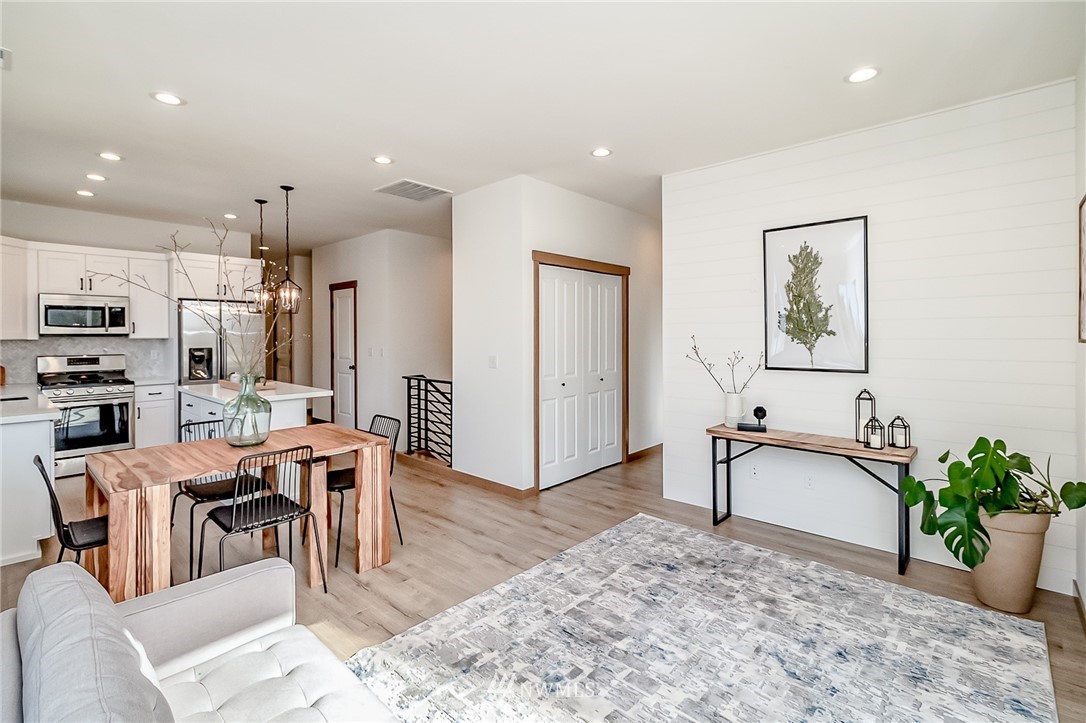 2624 Callow Road, Unit B Lake Stevens, WA 98258 - Photo 23 of 37 a view of a dining room kitchen with stainless steel appliances kitchen island granite countertop a table and chairs in it