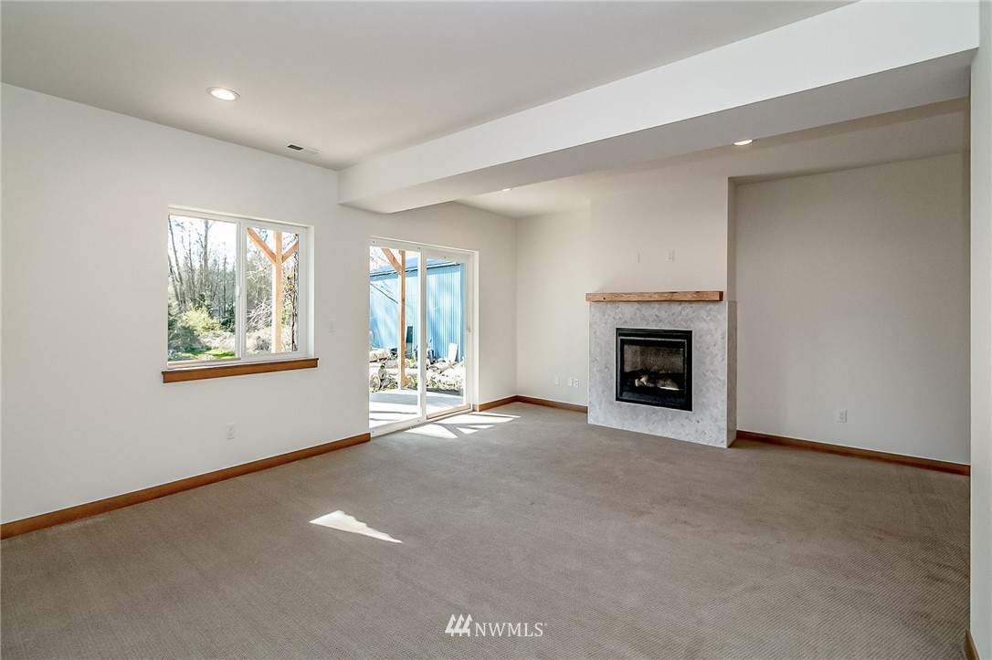 2624 Callow Road, Unit B Lake Stevens, WA 98258 - Photo 31 of 37 an empty room with windows and fireplace