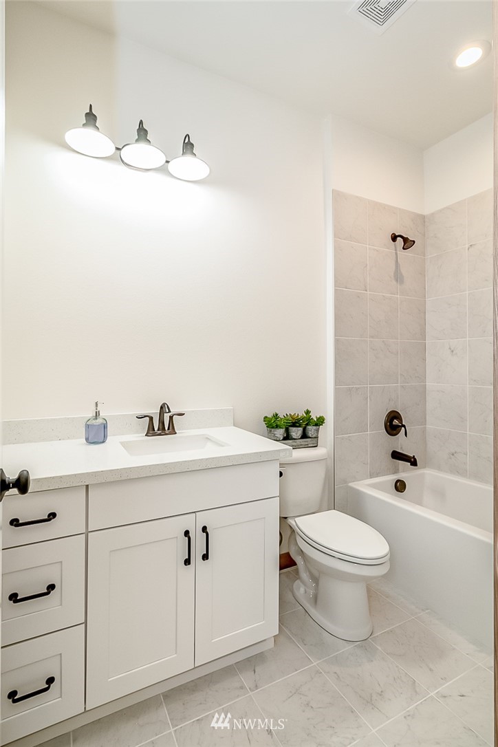 2624 Callow Road, Unit B Lake Stevens, WA 98258 - Photo 9 of 37 a bathroom with a sink a toilet and a mirror