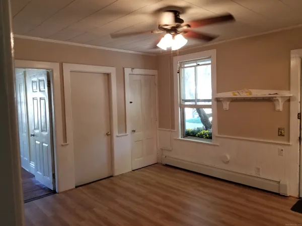 wooden floor in an empty room with a window