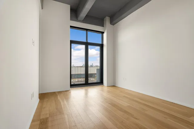 a bedroom with a bed and cabinets