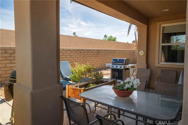 a front view of a house with outdoor seating