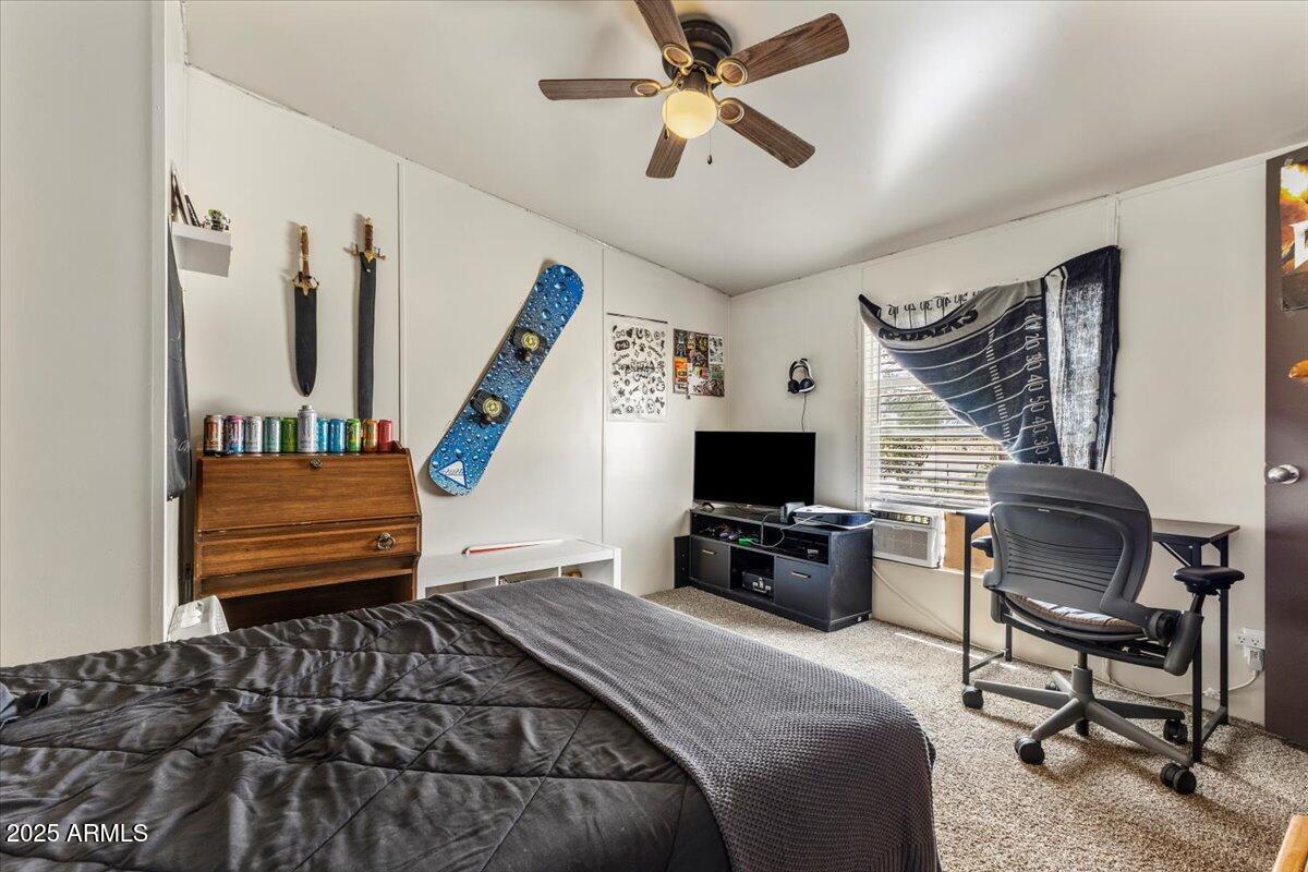 936 Paper Mill Road Taylor, AZ 85939 - Photo 15 of 43 a bedroom with a bed a computer on a desk and a book shelf