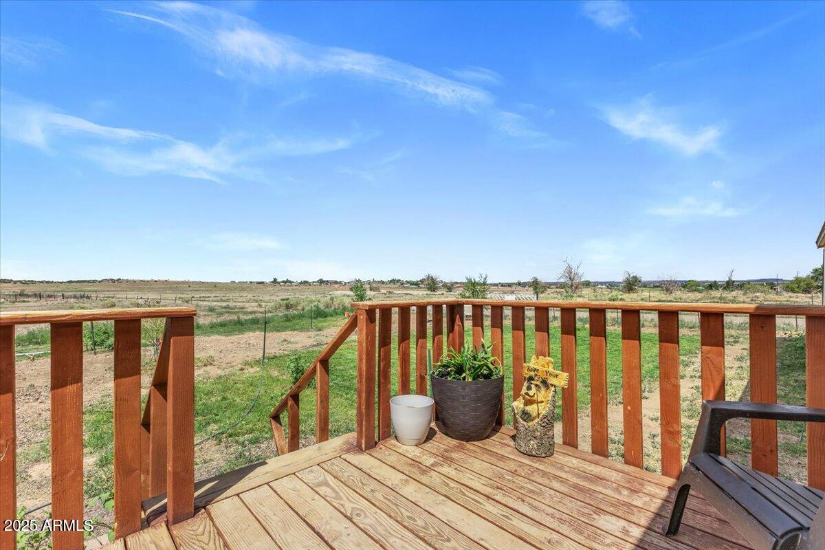 936 Paper Mill Road Taylor, AZ 85939 - Photo 21 of 43 a view of a balcony with wooden floor and fence