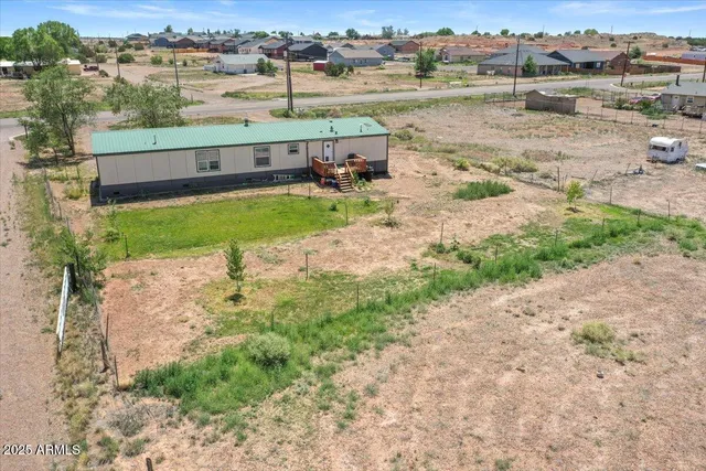 an aerial view of a house with big yard and lake view