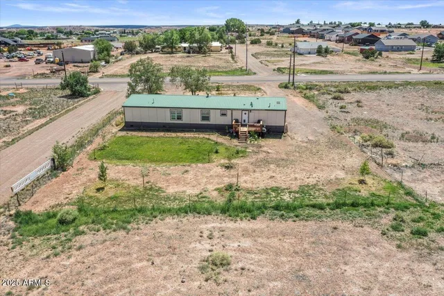 an aerial view of a house with a yard and lake view
