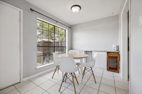 a view of a dining room with furniture and a window