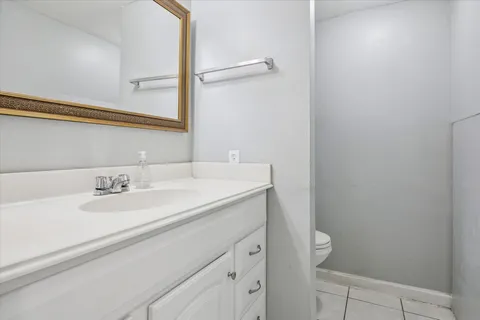 a bathroom with a sink a toilet and a mirror