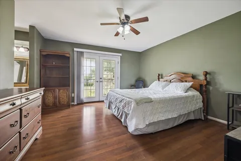 a bedroom with a bed and a dresser next to a window