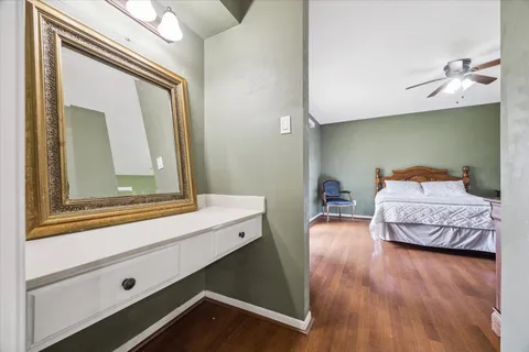 a bedroom with a bed and wooden floor