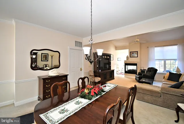 a living room with furniture a rug and a chandelier