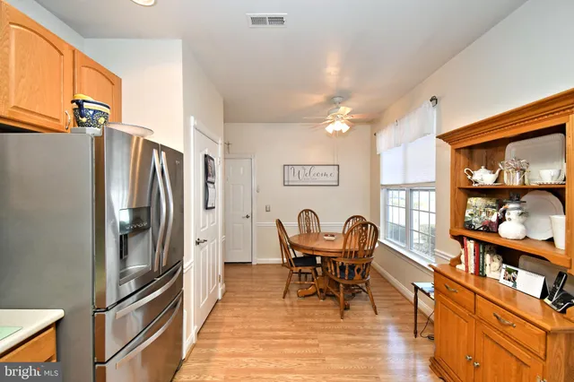 a view of a dining room with furniture a rug and wooden floor