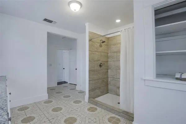 a bathroom with a shower and a sink