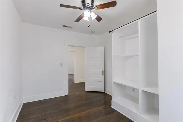 a view of walk in closet with empty racks