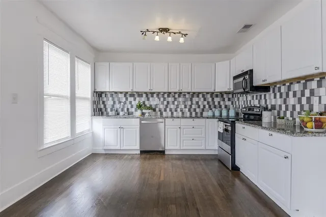 a kitchen with sink cabinets and window