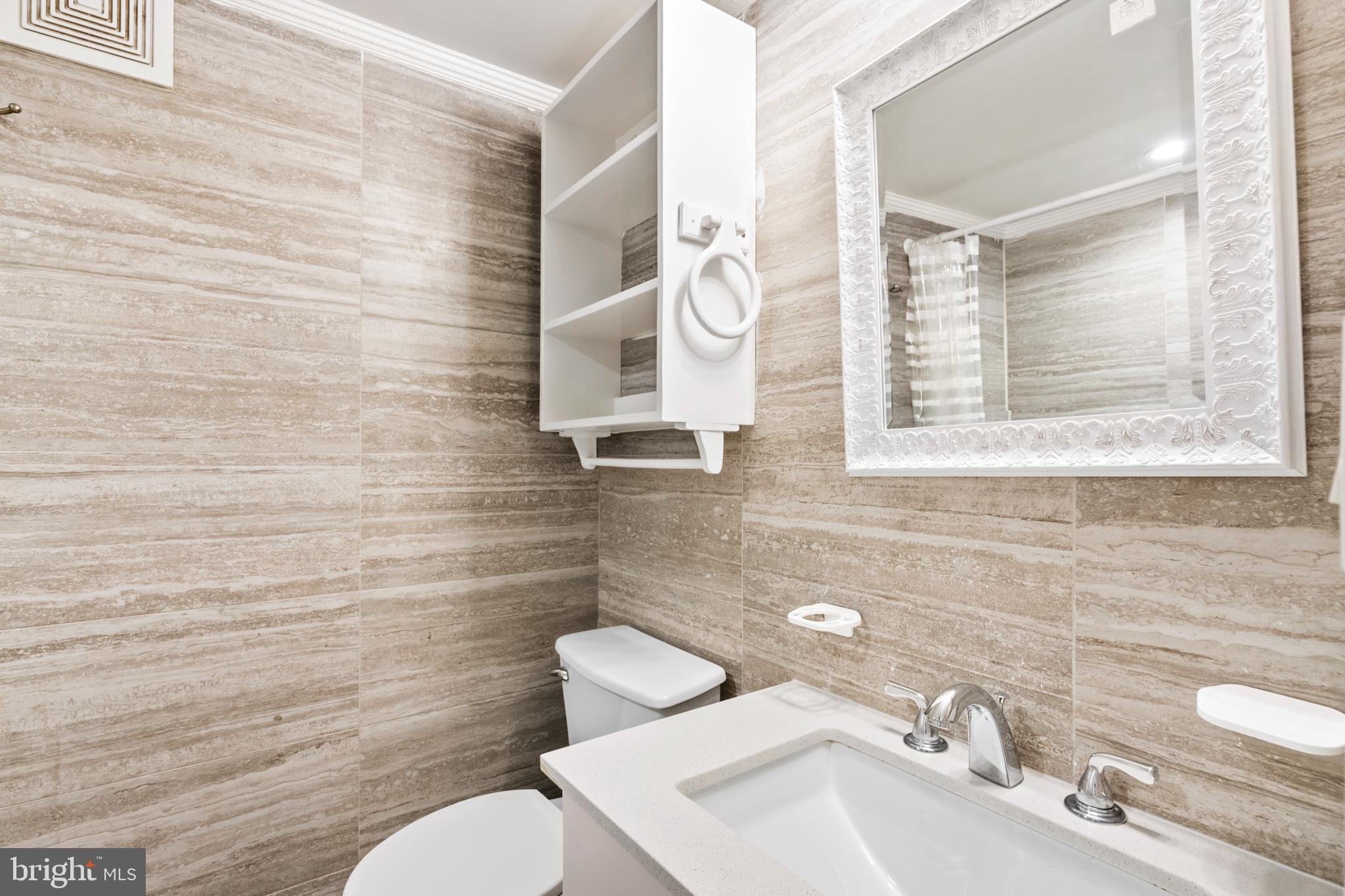 966 Mt Olivet Road Northeast Washington, DC 20002 - Photo 14 of 21 a bathroom with a toilet sink and mirror