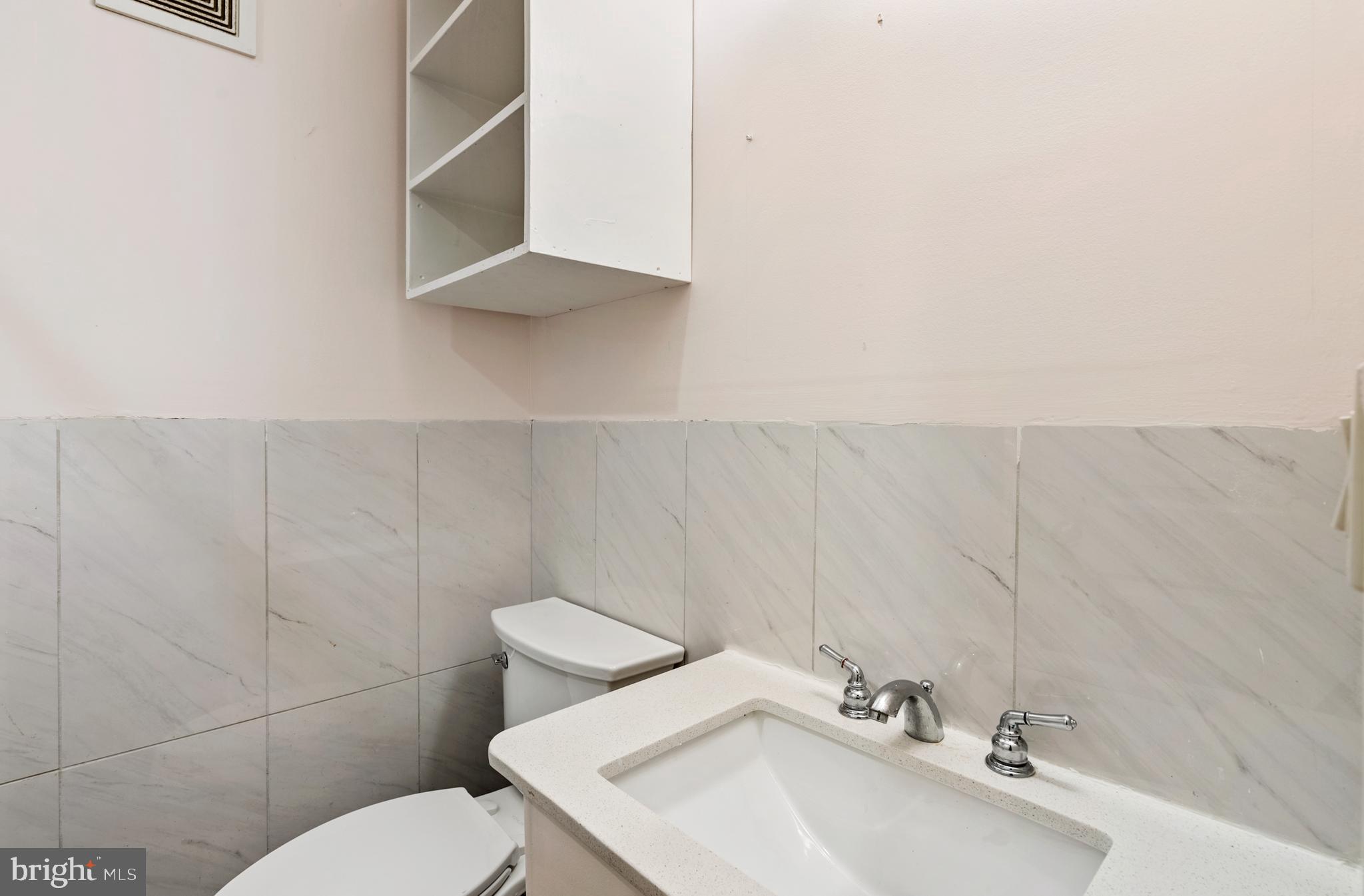 966 Mt Olivet Road Northeast Washington, DC 20002 - Photo 15 of 21 a bathroom with a sink mirror and toilet