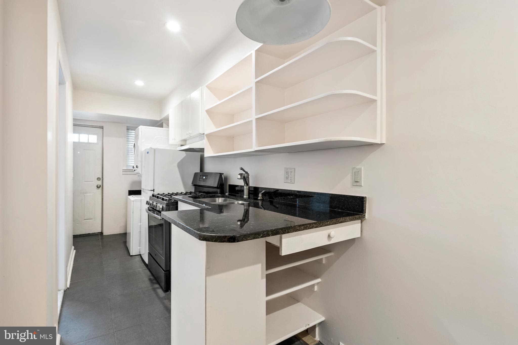 966 Mt Olivet Road Northeast Washington, DC 20002 - Photo 3 of 21 a kitchen with a sink and a stove top oven with wooden floor