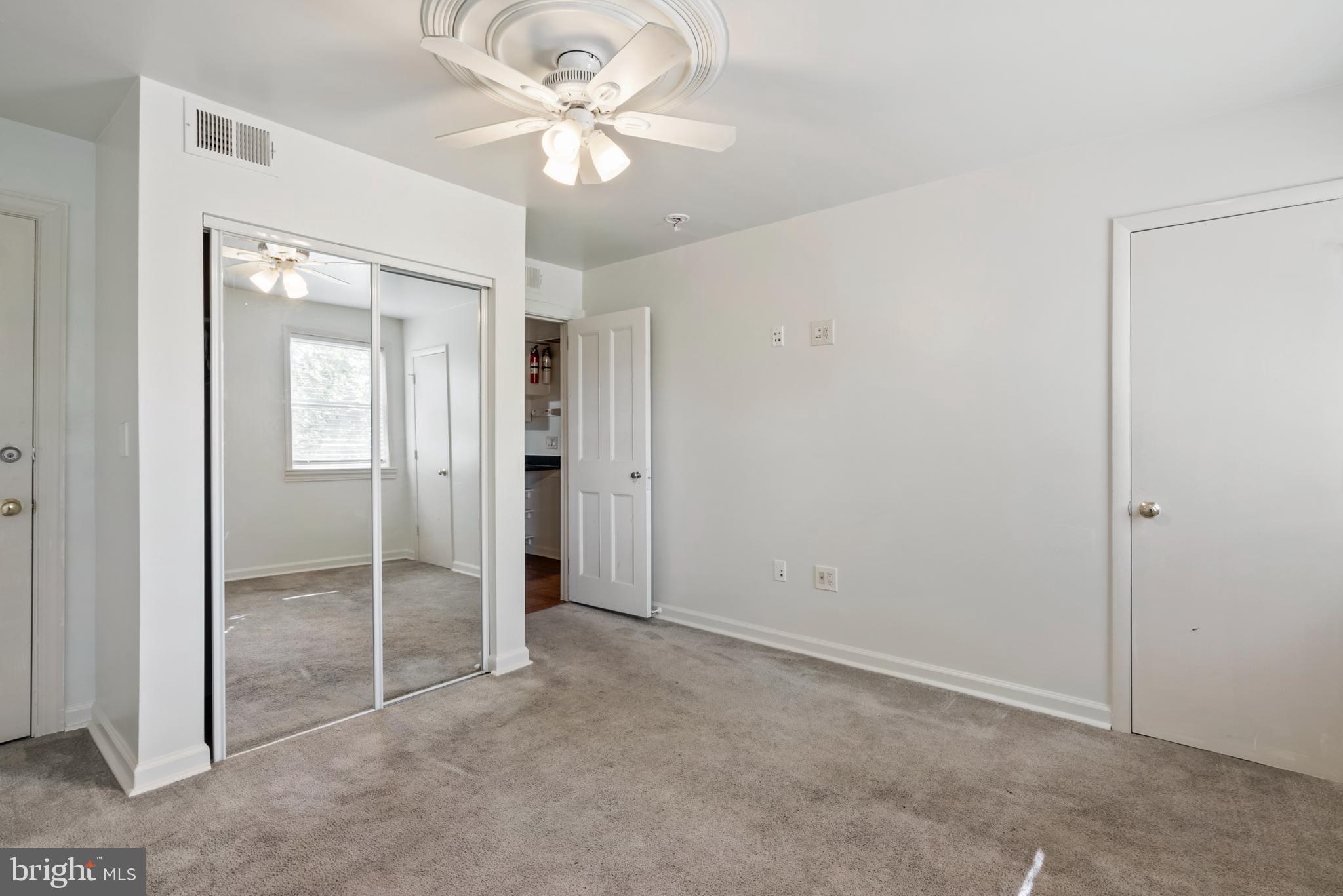 966 Mt Olivet Road Northeast Washington, DC 20002 - Photo 9 of 21 an empty room with closet and a ceiling fan