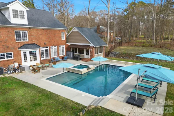 a view of a house with swimming pool and sitting area