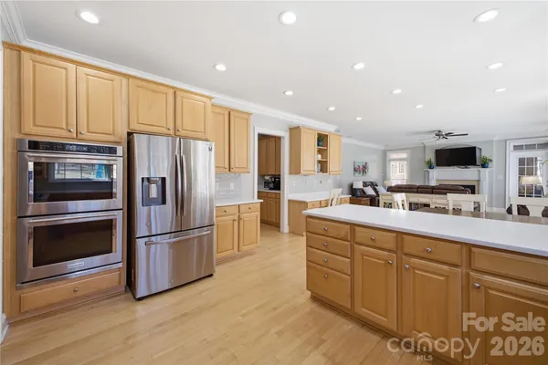 a kitchen with stainless steel appliances a refrigerator sink and microwave