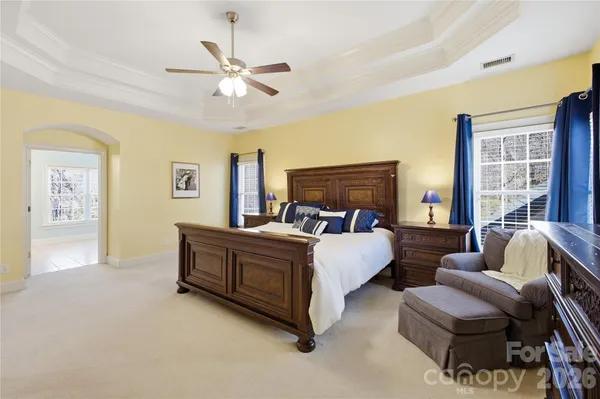 a bed room with bed and a large window