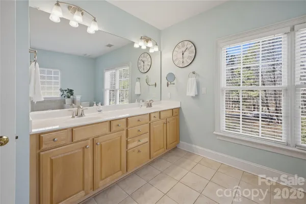 a spacious bathroom with a mirror a sink and a large mirror