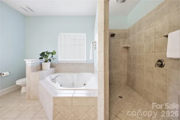 a white bath tub sitting next to a white toilet