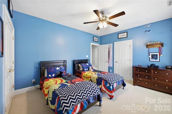 a bedroom with a bed and ceiling fan