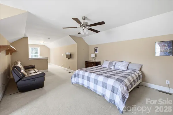 a bedroom with a bed couch and window