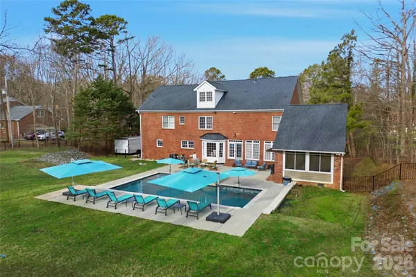 an aerial view of a house with a big yard