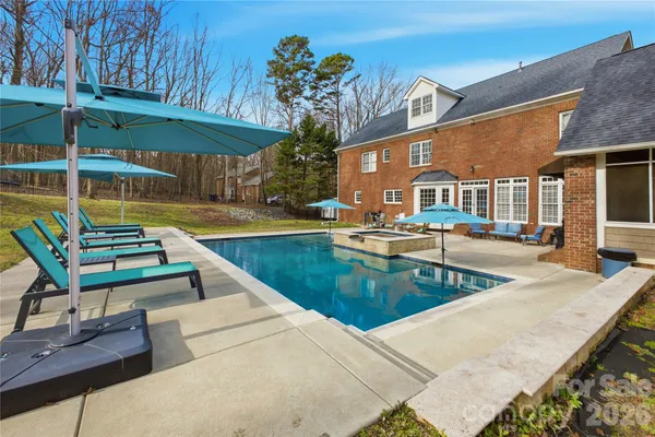 a view of a patio with swimming pool table and chairs