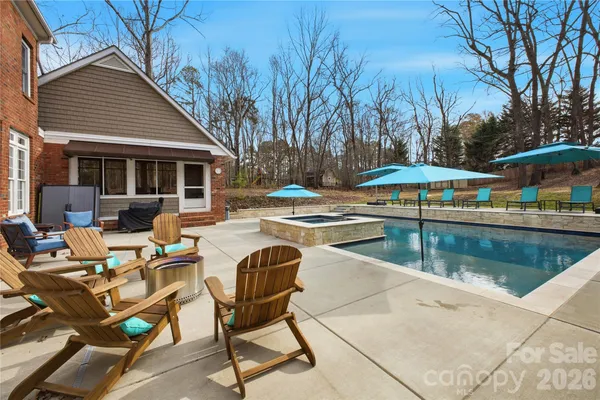 a view of swimming pool with outdoor seating and plants