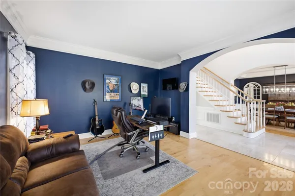 a living room with furniture and a lamp