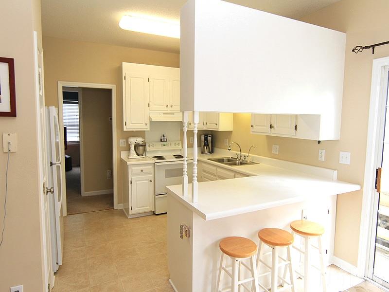 6844 Coventry Ridge Road Raleigh, NC 27616 - Photo 4 of 13 a kitchen with a sink and chairs