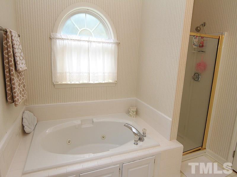 6844 Coventry Ridge Road Raleigh, NC 27616 - Photo 8 of 13 a white bath tub sitting next to a window