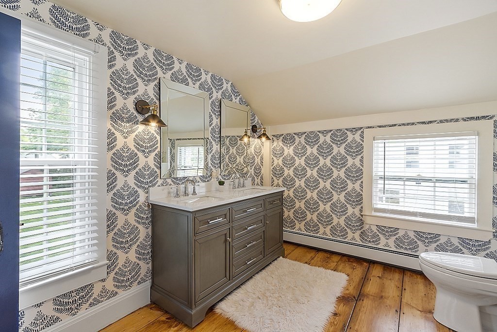 228 Main Street Groton, MA 01450 - Photo 26 of 35 a bathroom with a double vanity sink mirror and a bathtub