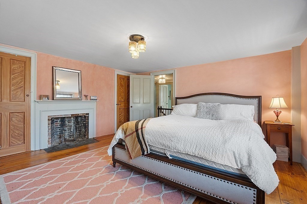 228 Main Street Groton, MA 01450 - Photo 28 of 35 a bedroom with a bed and a fireplace