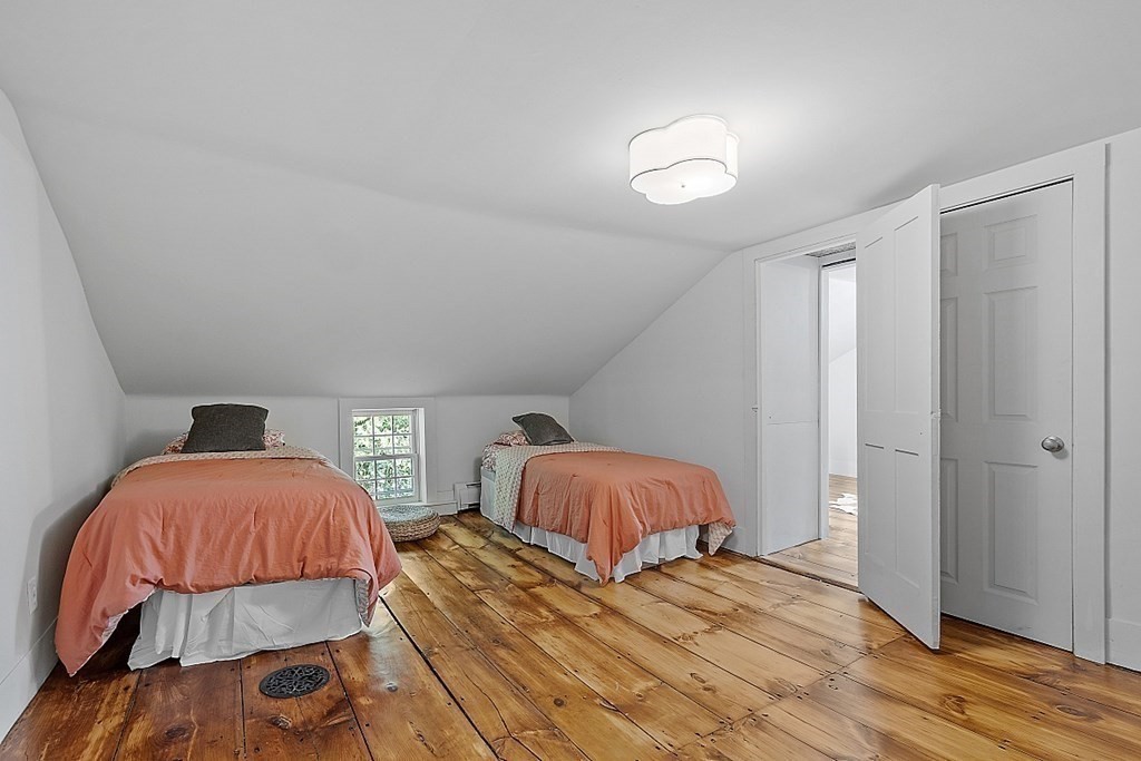 228 Main Street Groton, MA 01450 - Photo 29 of 35 a bedroom with a bed and wooden floor