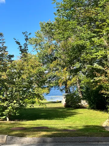 a view of yard with swimming pool and green space