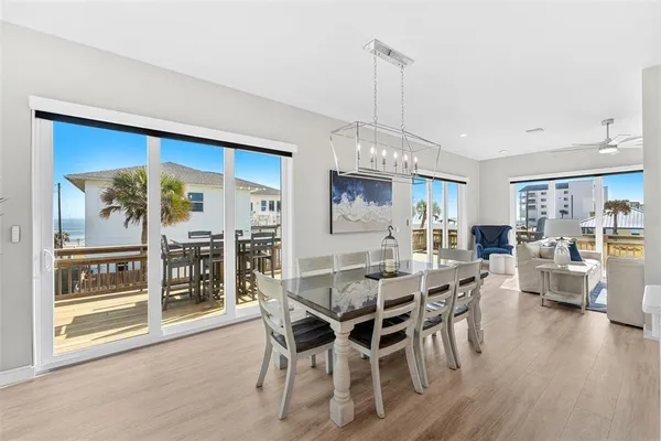 a kitchen with stainless steel appliances kitchen island granite countertop a wooden floor and white cabinets