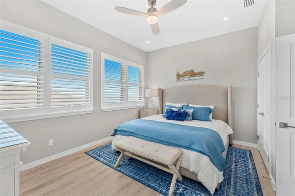 a bedroom with a bed a window and couch
