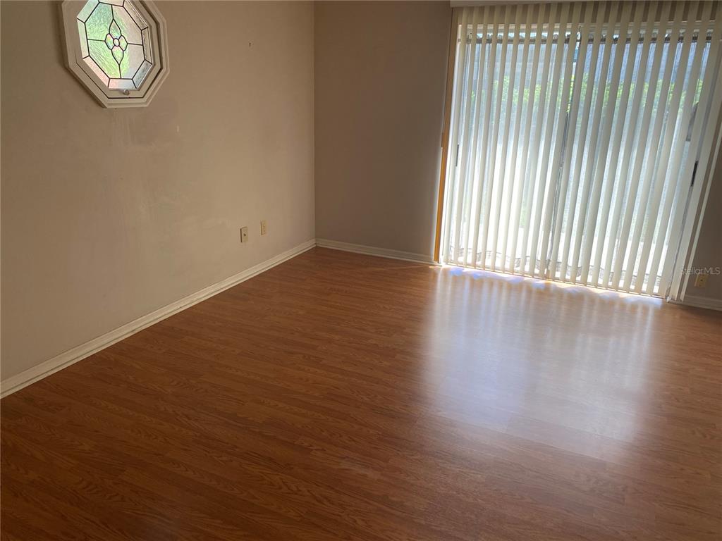 656 Boniview Lane Altamonte Springs, FL 32714 - Photo 12 of 17 an empty room with wooden floor and windows